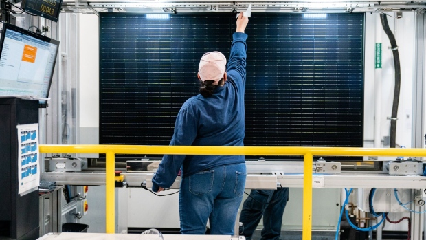 <p>A quality control worker checks a solar panel at a solar cell and module manufacturing facility in Dalton, Georgia.</p>
