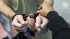 A correctional officer handcuffs an inmate at the Bayamon 705 correctional facility in Bayamon, Puer