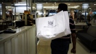 A customer holds a shopping bag inside the Hudson's Bay Co. flagship store in Toronto, Ontario, Canada, on Monday, Aug. 19, 2019. Canadian private equity firm Catalyst Capital Group Inc. bought a 10% stake in Hudson's Bay through a previously announced tender offer as part of its efforts to block a proposed takeover by the retailer's chairman. 