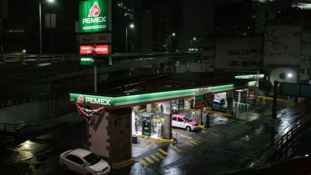 Vehices refuel at a Petroleos Mexicanos (Pemex) gas station at night in Mexico City, Mexico, on Monday, Aug. 6, 2018. Mexico's incoming president named a new chief executive officer for Pemex and promised government investment of 75 billion pesos ($4 billion) in the oil sector, in a bid to revive the state-owned oil company. 