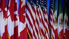 Canadian, American and Mexican flags stand on stage ahead of the first round of North American Free Trade Agreement (NAFTA) renegotiations in Washington, D.C., U.S., on Wednesday, Aug. 16, 2017. Canada and Mexico largely want to defend the advantages they have enjoyed under the two-decade-old Nafta deal, keep it free of tariffs and broaden it to new industries. President Donald Trump has called Nafta the worst trade pact in history and promised to fix it through negotiations or withdraw. 