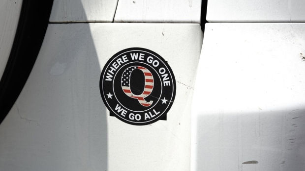 A QAnon bumper sticker is seen on a car outside a campaign rally for U.S. President Donald Trump at Yuma International Airport in Yuma, Arizona, U.S., on Tuesday, Aug. 18, 2020. 