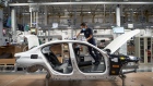 An employee assembles sunroof components on a Bayerische Motoren Werke AG (BMW) Series 3 vehicle on the production floor of the company's manufacturing facility in San Luis Potosi, Mexico, on Wednesday, April 21, 2021. BMW Group Plant San Luis Potosi started operations in 2019 with the production of the new generation of the BMW 3 Series. The plant currently employees 2,800 employees. Photographer: Mauricio Palos/Bloomberg