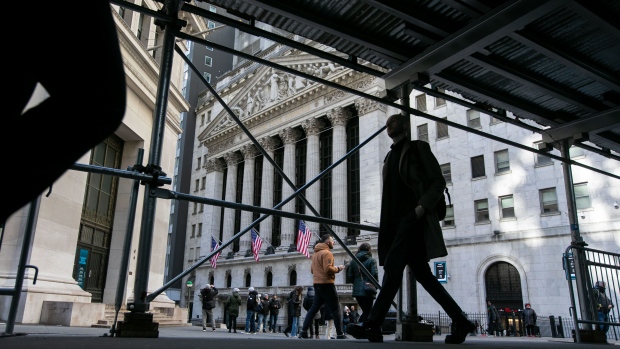 Pedestrians in front of the New York Stock Exchange (NYSE) in New York, US, on Friday, Feb. 16, 2024. Wall Street is ending the week on a bit of a sour note, with stocks and bonds falling after economic data continued to fuel speculation the Federal Reserve will be in no rush to cut interest rates. Photographer: Michael Nagle/Bloomberg