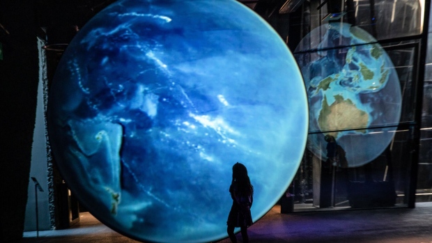 <p>A child inspects a large-scale projection of planet earth at the Museum of Natural Sciences of Barcelona, a designated climatic refuge, part of Barcelona’s Climate Shelter Network, where residents can take shelter during extreme heat.</p>