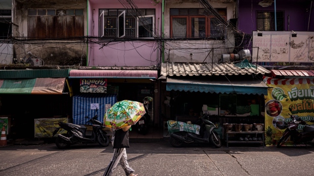 A woman uses an umbrella against the sun during a heatwave in Bangkok.