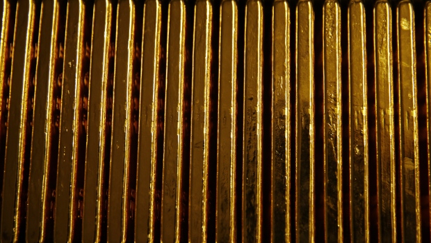 Bars of gold bullion sit underneath a 12.5 kilogram gold bar at the Valcambi SA precious metal refinery in Balerna, Switzerland, on Tuesday, April 24, 2018. Gold's haven qualities have come back in focus this year as President Donald Trump’s administration picks a series of trade fights with friends and foes, and investors fret about equity market wobbles that started on Wall Street and echoed around the world. 