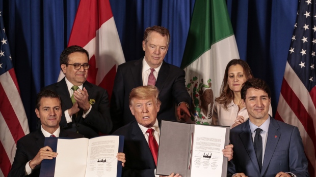 Enrique Pena Nieto, Mexico's president, from front left, U.S. president Donald Trump, and Justin Trudeau, Canada's prime minister, sit for photographs as Ildefonso Guajardo Villarreal, Mexico's secretary of economy, from back left, Robert Lighthizer, U.S. trade representative, and Chrystia Freeland, Canada's minister of foreign affairs, stand after signing the United States-Mexico-Canada Agreement (USMCA) at the G-20 Leaders' Summit in Buenos Aires, Argentina, on Friday Nov. 30, 2018. The U.S., Canada and Mexico are set to sign their new trade deal Friday following a year of intense negotiations to revamp the continent's free trade zone - after President Trump threats to kill it. Photographer: Sarah Pabst/Bloomberg