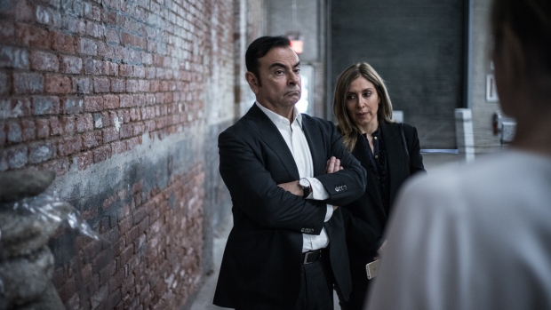 Carlos Ghosn, chairman of Renault SAS, Nissan Motor Co., and Mitsubishi Motors Corp., left, and his wife Carole Nahas view artwork at the DIA Art Foundation in the Chelsea neighborhood of New York, U.S., on Saturday, May 6, 2017. Ghosn's celebrated specialty is resuscitating companies from near death. He first did it in the mid-1990s at Renault, where he slashed costs, and pulled the company back into profitability. Photographer: Misha Friedman/Bloomberg 