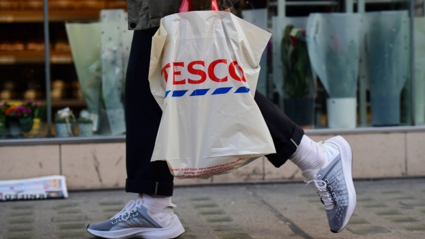 A customer carries a bag of shopping from a Tesco Plc supermarket in London, U.K., on Tuesday, Jan. 8, 2019. Investors looking for relief from the tumult of global markets may want to avert their eyes from a report showing that by one measure, U.K. retail sales had their worst year in more than a decade. Photographer: Chris J. Ratcliffe/Bloomberg