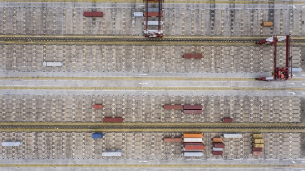 Shipping containers sit at the Yangshan Deep Water Port in this aerial photograph taken in Shanghai, China, on Tuesday, Feb. 4, 2020. Chinese officials are hoping the U.S. will agree to some flexibility on pledges in their phase-one trade deal, people familiar with the situation said, as Beijing tries to contain a health crisis that threatens to slow domestic growth with repercussions around the world. Photographer: Qilai Shen/Bloomberg