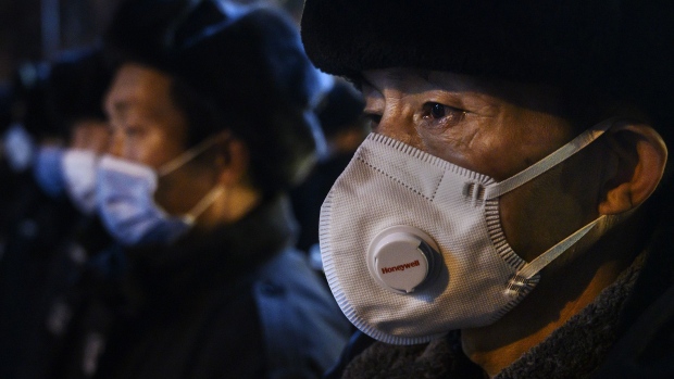 BEIJING, CHINA - FEBRUARY 09: A Chinese security guard wears a protective mask as he lines up with others on February 9, 2020 in Beijing, China. The number of cases of a deadly new coronavirus rose to more than 37000 in mainland China Sunday, days after the World Health Organization (WHO) declared the outbreak a global public health emergency. China continued to lock down the city of Wuhan in an effort to contain the spread of the pneumonia-like disease which medicals experts have confirmed can be passed from human to human. In an unprecedented move, Chinese authorities have put travel restrictions on the city which is the epicentre of the virus and municipalities in other parts of the country affecting tens of millions of people. The number of those who have died from the virus in China climbed to over 810 on Sunday, mostly in Hubei province, and cases have been reported in other countries including the United States, Canada, Australia, Japan, South Korea, India, the United Kingdom, Germany, France and several others. The World Health Organization has warned all governments to be on alert and screening has been stepped up at airports around the world. Some countries, including the United States, have put restrictions on Chinese travelers entering and advised their citizens against travel to China. (Photo by Kevin Frayer/Getty Images)