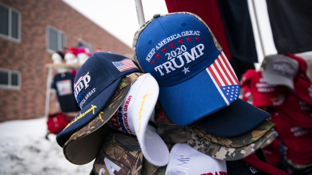 Campaign hats are displayed for sale outside a rally with U.S. President Donald Trump in Des Moines, Iowa on Jan. 30, 2020. Photographer: Al Drago/Bloomberg