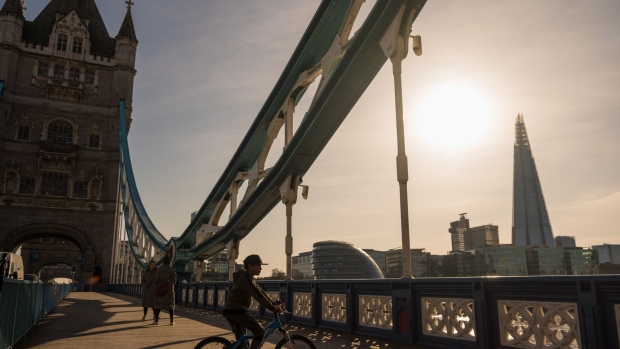 A cyclist stops on Tower Bridge in view of The Shard in London, U.K., on Tuesday, March 24, 2020. The U.K. is in lockdown after Boris Johnson ordered sweeping measures to stop people leaving their homes "at this moment of national emergency." Photographer: Jason Alden/Bloomberg