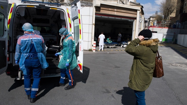 Members of the civil protection ambulance service load an emergency response vehicle before making house calls in Paris, March 31. Photographer: Nathan Laine/Bloomberg