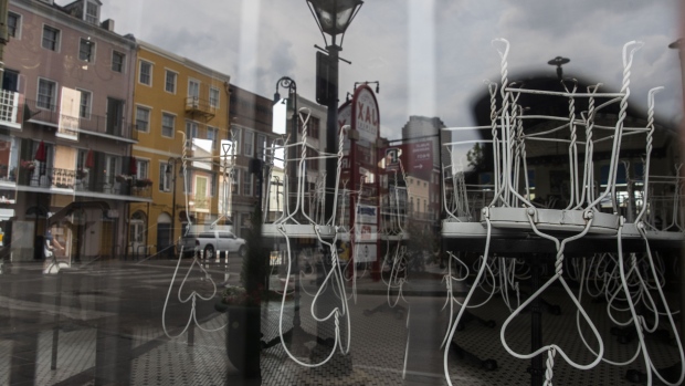 Chairs sit on the tables of a closed cafe in the French Quarter neighborhood of New Orleans on April 8. Photographer: Sophia Germer/Bloomberg