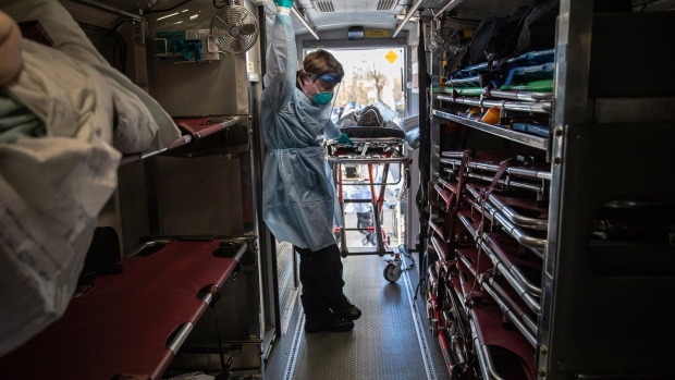 An EMT pauses while unloading COVID-19 patients at the Montefiore Medical Center Wakefield Campus in the Bronx borough of New York City on April 6. Photographer: John Moore/Getty Images