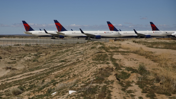 Delta Air Lines aircraft sit parked at a field in Victorville, California on March 23. Photographer: Patrick T. Fallon/Bloomberg