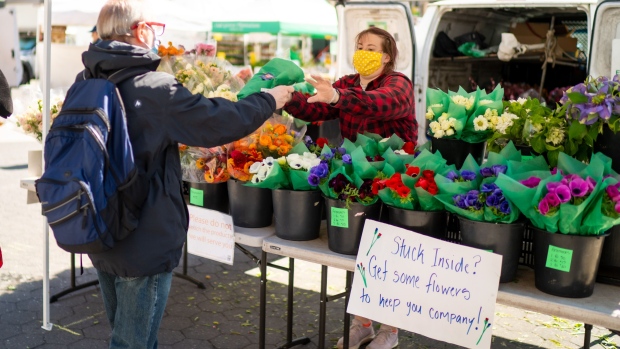 A customer buys flowers at the Union Square farmers market in New York City on April 15.