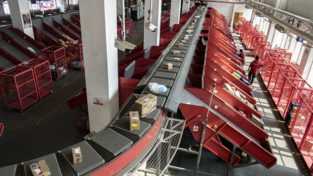 Parcels move along a conveyor at a JD.com Inc. delivery station in Beijing, China, on Tuesday, April 14, 2020. JD, China's closest analog to Amazon.com Inc., already serves more than 360 million people -- surpassing the U.S. population. Xu Lei, chief executive officer of JD's retail division, now hopes to extend its presence on social media and investing in hot new areas like grocery delivery. Photographer: Giulia Marchi/Bloomberg
