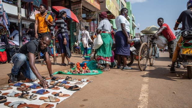 A street vendor arranges a display of sandals for sale in downtown Kampala on June 23. Photographer: Esther Ruth Mbabazi/Bloomberg