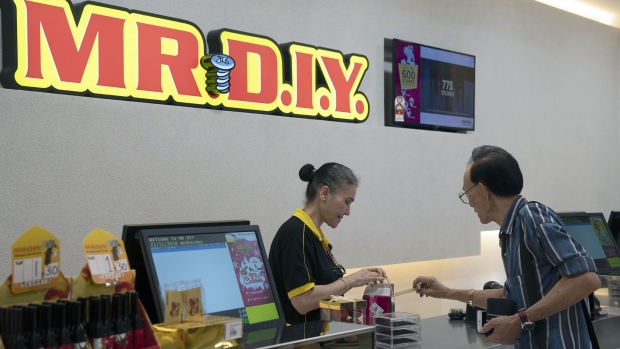 An employee assists a customer at Mr. DIY Sdn. hardware store inside CapitaLand Ltd.'s Westgate Mall in Singapore, on Wednesday, Nov. 21, 2018. Online shopping in Singapore is lackluster even after Amazon Inc. debuted its Prime service in mid-2017. The islands malls are trying hard to keep it that way.