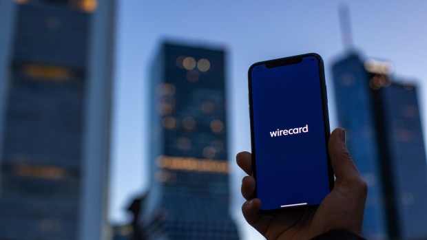 The Wirecard AG app is displayed on an Apple Inc. iPhone X smartphone in this arranged photograph near skyscrapers in the financial district in Frankfurt, Germany, on Tuesday, June 30, 2020. Singapore’s financial regulators are working with local police to scrutinize aspects of the case surrounding Wirecard AG, the scandal-ridden German payments company. Photographer: Alex Kraus/Bloomberg