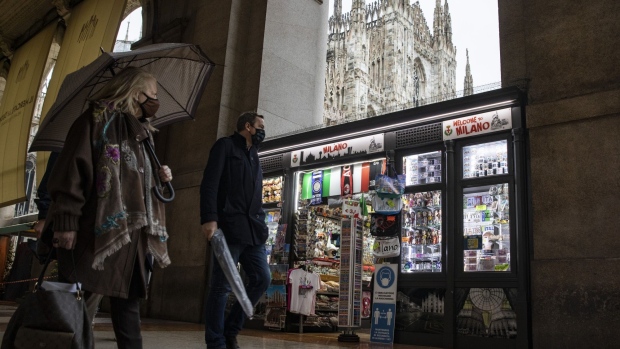 Pedestrians wearing protective masks walk through Duomo Square in Milan, Italy, on Monday, Oct. 26, 2020. Italy introduced its strongest virus restrictions since the end of a lockdown in May, and Spain will impose new measures, including a nationwide curfew.