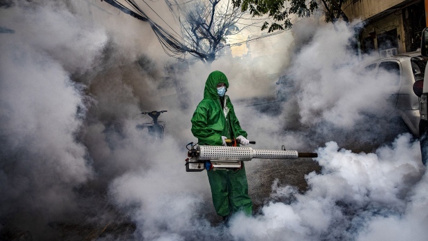 MANILA, PHILIPPINES - MARCH 26: A worker wearing a hazmat suit uses a fogging machine to disinfect a street as preventive measure against COVID-19 on March 26, 2021 in Manila, Philippines. Curfews and stricter lockdowns are being implemented in several areas across the Philippines as the country experiences its worst surge in cases since the lockdown began more than a year ago. The country has reported more than 693,000 cases of COVID-19 so far, with at least 13,095 deaths. (Photo by Ezra Acayan/Getty Images) Photographer: Ezra Acayan/Getty Images AsiaPac