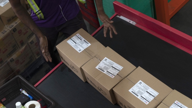 A Qxpress worker puts packages for delivery on a conveyor belt at a Qoo10 Pte. warehouse in Singapore, on Thursday, April 9, 2020. An e-commerce boom comes as the spread of the coronavirus led to lockdowns in Singapore, Malaysia and the Philippines, while many consumers stay home in Indonesia and Thailand to avoid the disease. Photographer: Wei Leng Tay/Bloomberg