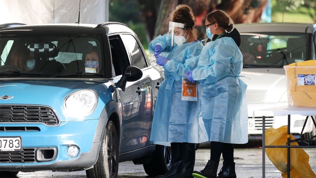 AUCKLAND, NEW ZEALAND - AUGUST 18: People are tested at a pop up Covid 19 testing station in Woodall Park carpark in Narrowneck, Devonport as Auckland wakes to level four lockdown and four more cases on August 18, 2021 in Auckland, New Zealand. The first reported case of the Covid Delta variant is a Devonport local. Level 4 lockdown restrictions have come into effect across New Zealand for the next three days, while Auckland and the Coromandel Peninsula will remain in lockdown for seven days after a positive COVID-19 case was confirmed in the community in Auckland on Tuesday. The positive case traveled to Coromandel over the weekend and the source of the infection is still unknown. New Zealand health officials are also yet to confirm whether it is the highly contagious Delta variant of the coronavirus. Under COVID-19 Alert Level 4 measures, people are instructed to stay at home in their bubble other than for essential reasons, with travel severely limited. All non-essential businesses are closed, including bars, restaurants, cinemas and playgrounds. All indoor and outdoor events are banned, while schools have switched to online learning. Essential services remain open, including supermarkets and pharmacies. (Photo by Fiona Goodall/Getty Images)