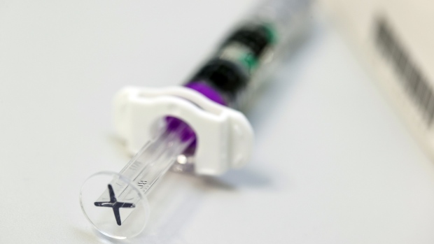 A syringe loaded with seasonal influenza vaccine, manufactured by GlaxoSmithKline Plc, at a doctor's surgery in an arranged photograph in Gelnhausen, Germany, on Tuesday, Nov. 24, 2020. The influenza viruses that infect people change constantly, so twice a year the World Health Organization makes its best guess about the strains likely to emerge the following year. Photographer: Alex Kraus/Bloomberg