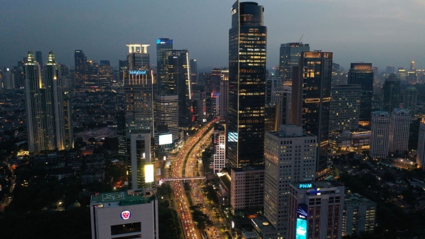Traffic at dusk in the central business district of Jakarta, Indonesia, on Friday, Nov. 5, 2021. Indonesia's economy decelerated in the third quarter as harsh lockdowns to contain a record spike in Covid-19 cases outweighed higher commodity prices and trade. Photographer: Dimas Ardian/Bloomberg