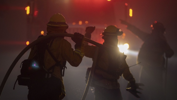 GOLETA, CA - OCTOBER 12: Firefighters battle the Alisal Fire at night on October 12, 2021 near Goleta, California. Pushed by high winds, the Alisal Fire grew to 6,000 acres overnight, shutting down the much-traveled 101 Freeway along the Pacific Coast. (Photo by David McNew/Getty Images)