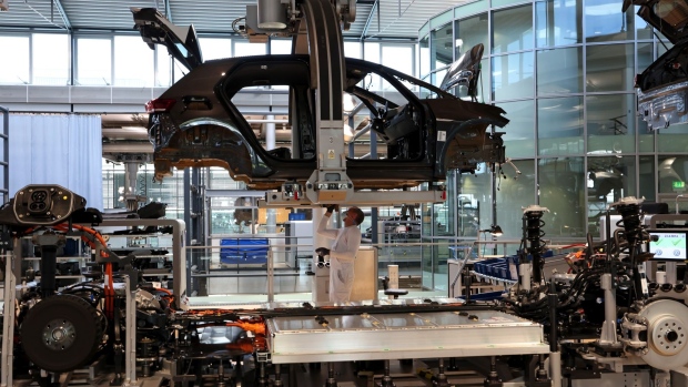 A worker prepares the undercarriage of a Volkswagen AG (VW) ID.3 electric automobile for battery pack installation at the automaker's factory in Dresden, Germany, on Tuesday, June 8, 2021. VW's supervisory board is proposing to investors to extend the contract of Chairman Hans Dieter Poetsch and board member Louise Kiesling for another term of five years at the next annual meeting, a spokesman said.