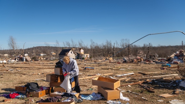 A resident surveys damage to a home following a tornado in Dawson Springs, Kentucky, U.S., on Saturday, Dec. 12, 2021. Tornadoes ripped across several U.S. states late Friday, killing more than 70 people in Kentucky, at least two at a nursing home in Arkansas and an undetermined number at an Amazon.com warehouse that was partially flattened in Illinois.
