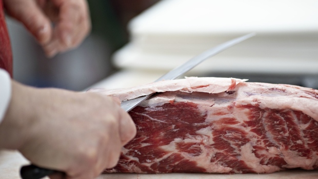 A butcher trims fat from a piece of beef in the meat department of a supermarket in Princeton, Illinois, U.S., on Thursday, April 16, 2020. Photographer: Daniel Acker/Bloomberg