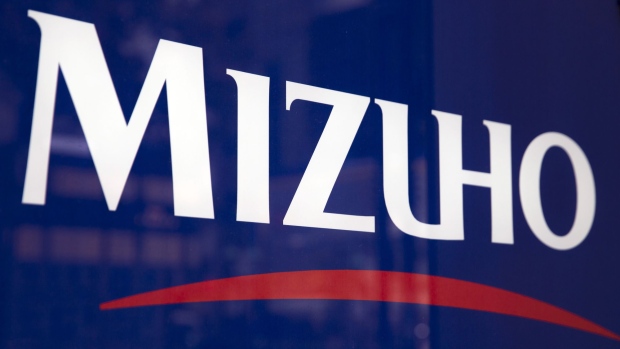 A Mizuho Bank Ltd. logo is displayed at one of the company's branches in Tokyo, Japan, on Monday, Nov. 14, 2016. Mizuho Financial Group Inc.’s second-quarter profit beat analysts’ estimates, barely falling as a one-time tax gain helped the Japanese bank make up for a drop in lending income exacerbated by negative interest rates. Photographer: Tomohiro Ohsumi/Bloomberg
