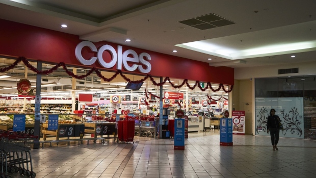 A customer leaves a Coles Group Ltd. supermarket in Melbourne, Australia, on Sunday, Nov. 7, 2021. Australian retailers suffered their worst quarter of sales on record as coronavirus-induced lockdowns along the nations heavily populated east coast slashed spending, underscoring expectations the economy contracted in the period.