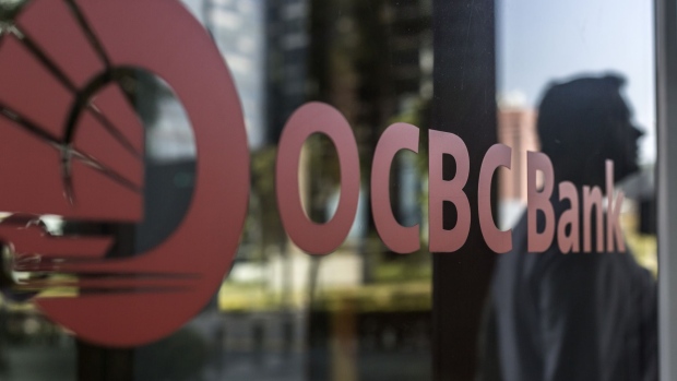 The Oversea-Chinese Banking Corp. (OCBC) logo is displayed on a glass panel at a branch in the central business district (CBD) of Singapore, on Saturday, Feb. 16, 2019. OCBC is scheduled to release full year earnings results on Feb. 22. Photographer: Ore Huiying/Bloomberg