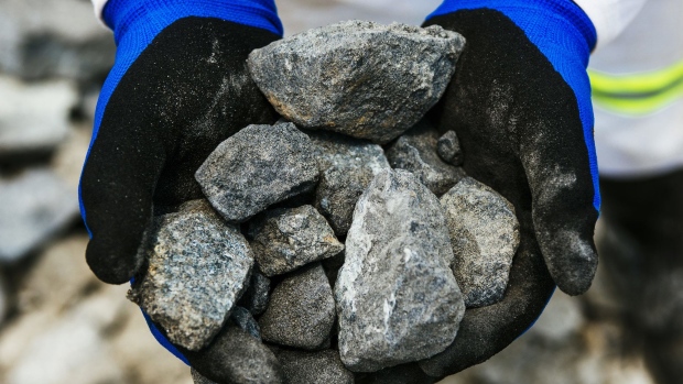 A worker holds rocks of raw platinum ore for a photograph at the Northam Platinum Ltd. Booysendal platinum mine, located outside the town of Lydenburg in Mpumalanga, South Africa, on Tuesday, Jan. 23, 2018. Booysendal will use a system developed by an Austrian company that builds ski lifts to transport the ore up a 30 degree incline out of a valley for processing, instead of the traditional conveyer used throughout South Africa or the more expensive option of trucking. Photographer: Bloomberg/Bloomberg