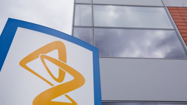 A sign featuring the AstraZeneca Plc logo stands near the company's DaVinci building at the Melbourn Science Park in Cambridge, U.K., on Monday, June 8, 2020. AstraZeneca Plc has made a preliminary approach to rival drugmaker Gilead Sciences Inc. about a potential merger, according to people familiar with the matter, in what would be the biggest health-care deal on record.