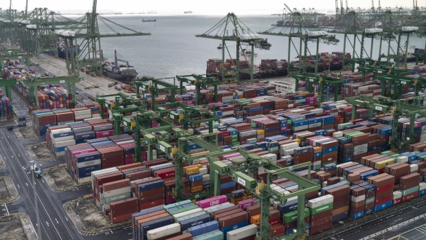 Containers are stacked near gantry cranes at the Port of Singapore in Singapore, on Wednesday, March 24, 2021. Singapore's non-oil domestic exports rose 4.2 percent in February from a year earlier, the International Enterprise Singapore said in an emailed statement.