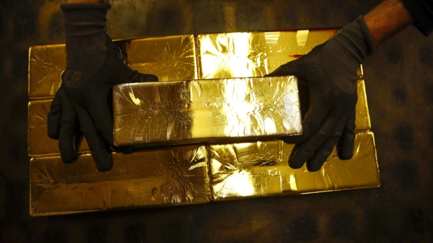 A worker stacks 12.5 kilogram gold bullion bars at the Valcambi SA precious metal refinery in Balerna, Switzerland, on Tuesday, April 24, 2018. Gold's haven qualities have come back in focus this year as President Donald Trump’s administration picks a series of trade fights with friends and foes, and investors fret about equity market wobbles that started on Wall Street and echoed around the world.