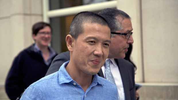 Roger Ng, a former banker for Goldman Sachs Group Inc., left, exits from federal court in the Brooklyn borough of New York, U.S., on Monday, May 6, 2019. Ng is in plea talks to avoid a U.S. trial on charges that he broke American anti-bribery laws and conspired to launder money embezzled from Malaysia's state investment fund 1MDB.