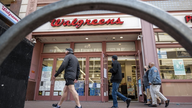 Pedestrians wearing protective masks walk past a Walgreens store in San Francisco, California, U.S., on Tuesday, April 13, 2021. Walgreens Boots Alliance Inc. is scheduled to release earnings figures on April 15. Photographer: David Paul Morris/Bloomberg