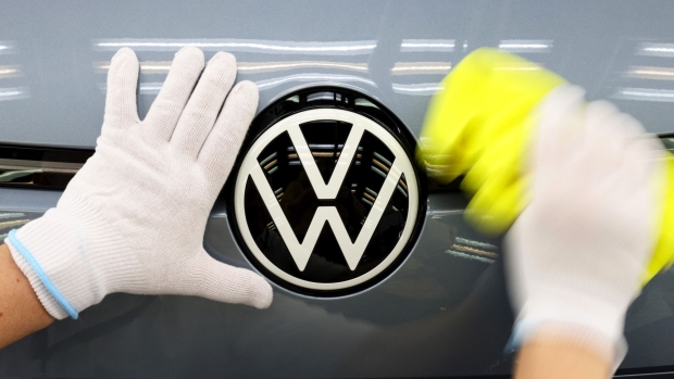 A worker polish the badge on a new Volkswagen AG (VW) ID.3 electric automobile on the final assembly line at the automaker's factory in Dresden, Germany, on Tuesday, June 8, 2021. VW's supervisory board is proposing to investors to extend the contract of Chairman Hans Dieter Poetsch and board member Louise Kiesling for another term of five years at the next annual meeting, a spokesman said. Photographer: Liesa Johannssen-Koppitz/Bloomberg