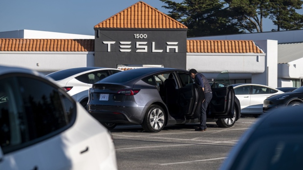 A Tesla dealership in Colma, California, U.S., on Wednesday, Jan. 26, 2022. U.S. auto sales will climb just 3.4% this year to 15.4 million cars and trucks as the semiconductor shortages continue to constrain vehicle inventory, auto dealers predict. Photographer: David Paul Morris/Bloomberg