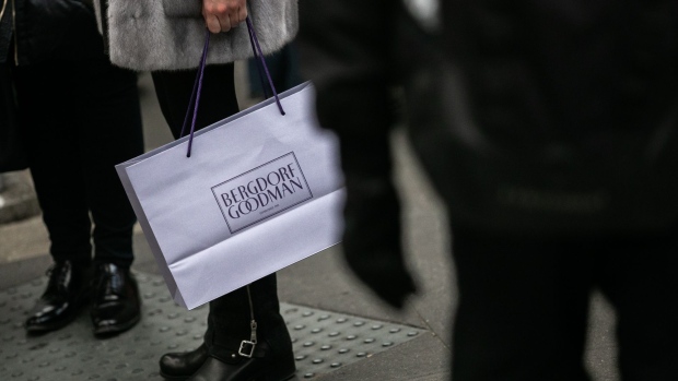 A shopper carries a Bergdorf Goodman Inc. retail bag on Madison Avenue in New York, U.S., on Wednesday, Nov. 21, 2018. The National Retail Federation, which measures the holiday season from Nov. 1 to Dec. 31, has high expectations, given a strong economy, rising consumer confidence and low unemployment. Photographer: Jeenah Moon/Bloomberg