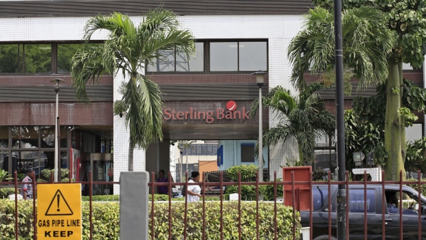 Pedestrians pass Sterling Towers, headquarters of Sterling Bank Plc, in Lagos, Nigeria, on Monday, Feb. 6, 2017. The Scottish city of Glasgow was just one stop in Sterling Bank Plc’s push to get Nigerians abroad to open 5,000 new accounts back home this year, said Tunji Adeyemi, head of diaspora-services at Sterling Bank Plc.